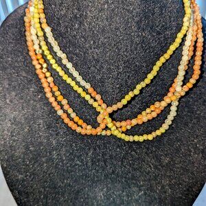 New collar style necklace with multi colored beads reminiscent of fall.